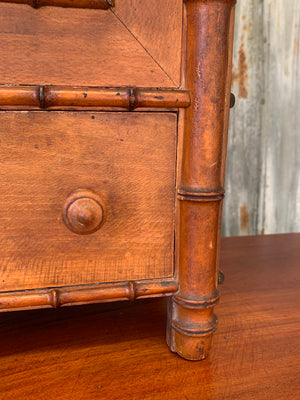 A small French faux bamboo mirrored cabinet