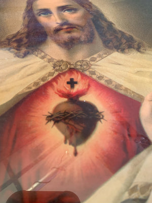 An early-20th Century framed print of the Jesus Christ Sacred Heart depiction