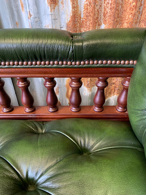 A Victorian-style green leather chaise longue