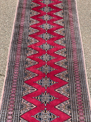 A long pink ground Persian runner rug ~ 318cm x 83cm