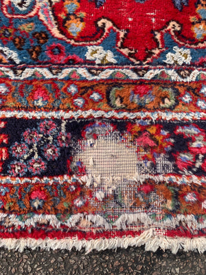 A large red ground Persian rug - 299cm x 194cm