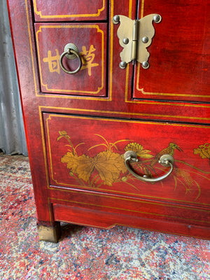 A red and gold lacquered chinoiserie cabinet