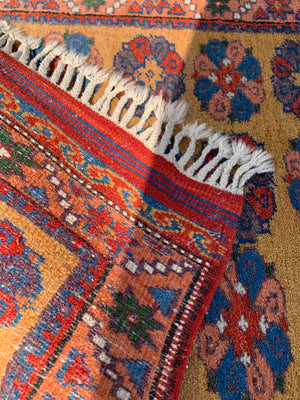 A long yellow ground red blue Persian runner rug ~ 257cm x 67cm