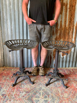 A cast iron adjustable tractor seat stool