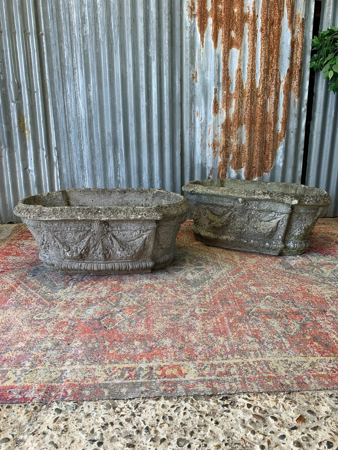 A pair of cast stone trough planters
