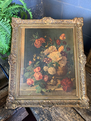 A framed floral oleograph