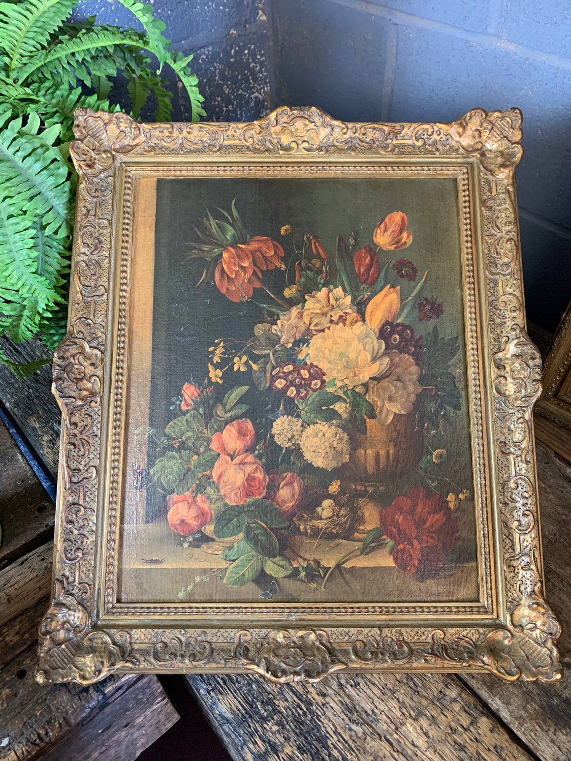 A framed floral oleograph