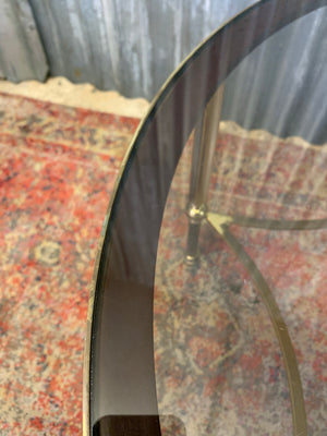A rare circular brass and glass Hollywood Regency coffee table