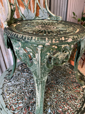 A green garden table and two chair bistro set