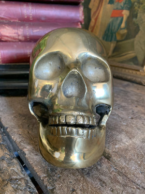 A life-size brass human skull model