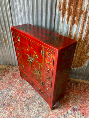 A red and gold lacquered chinoiserie cabinet