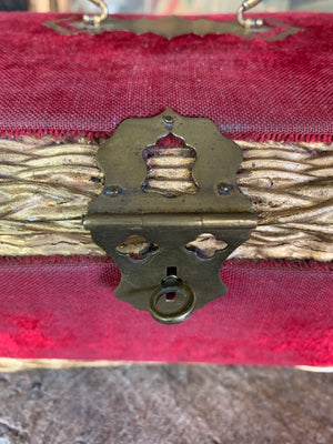 An ornate red velvet casket