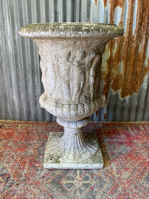 A very large Neoclassical cast stone urn with twin head motif