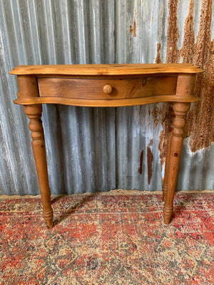 A single drawer serpentine front pine console table