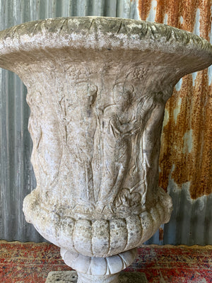 A very large Neoclassical cast stone urn with twin head motif