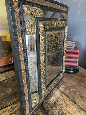 An ebonised cushion mercury mirror