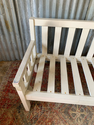 A large slatted wooden garden bench