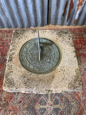 A large cast stone sundial on a column stand