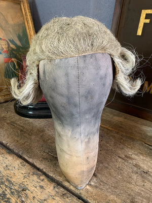 An oversized canvas head block or wig stand