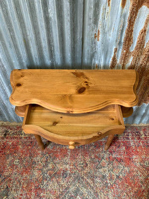 A single drawer serpentine front pine console table
