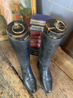 A pair of black leather riding boots with wooden lasts ~ ring pulls