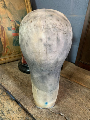 An oversized canvas head block or wig stand