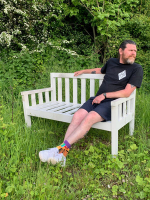 A large slatted wooden garden bench