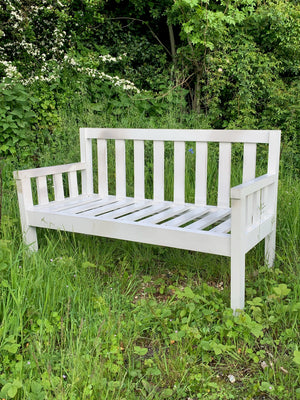 A large slatted wooden garden bench