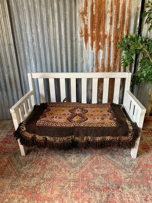 A large slatted wooden garden bench