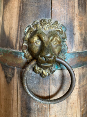 A wooden barrel stick stand with lion head handles