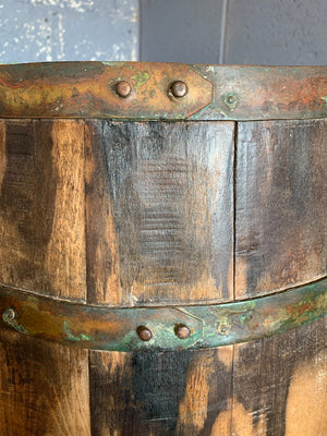 A wooden barrel stick stand with lion head handles