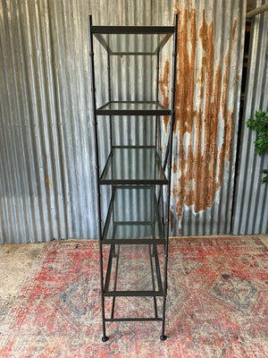 A faux bamboo metal and glass etagere