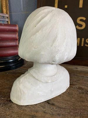 A plaster bust of a young girl by Hermann Würth- signed and dated