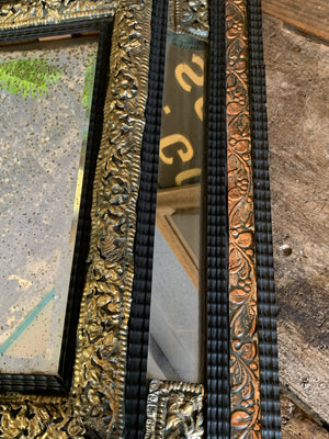 An ebonised cushion mercury mirror