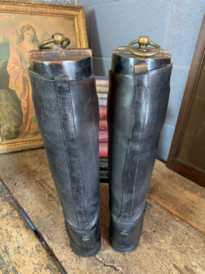 A pair of black leather riding boots with wooden lasts ~ ring pulls