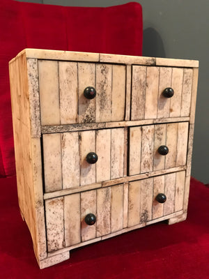 A small mosaic bone covered collector’s cabinet of drawers