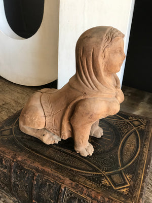 A hand-carved wooden Egyptian sphinx figure