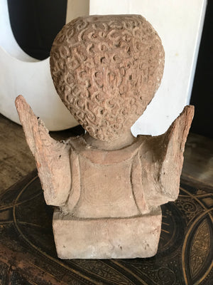 A hand-carved wooden cherub bust