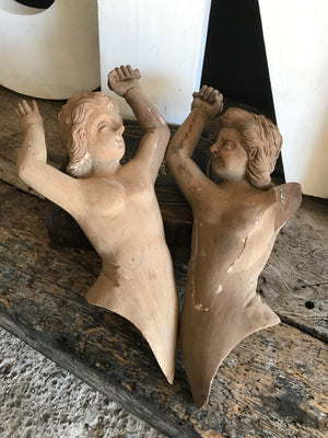 A pair of wooden hand-carved cherub figures