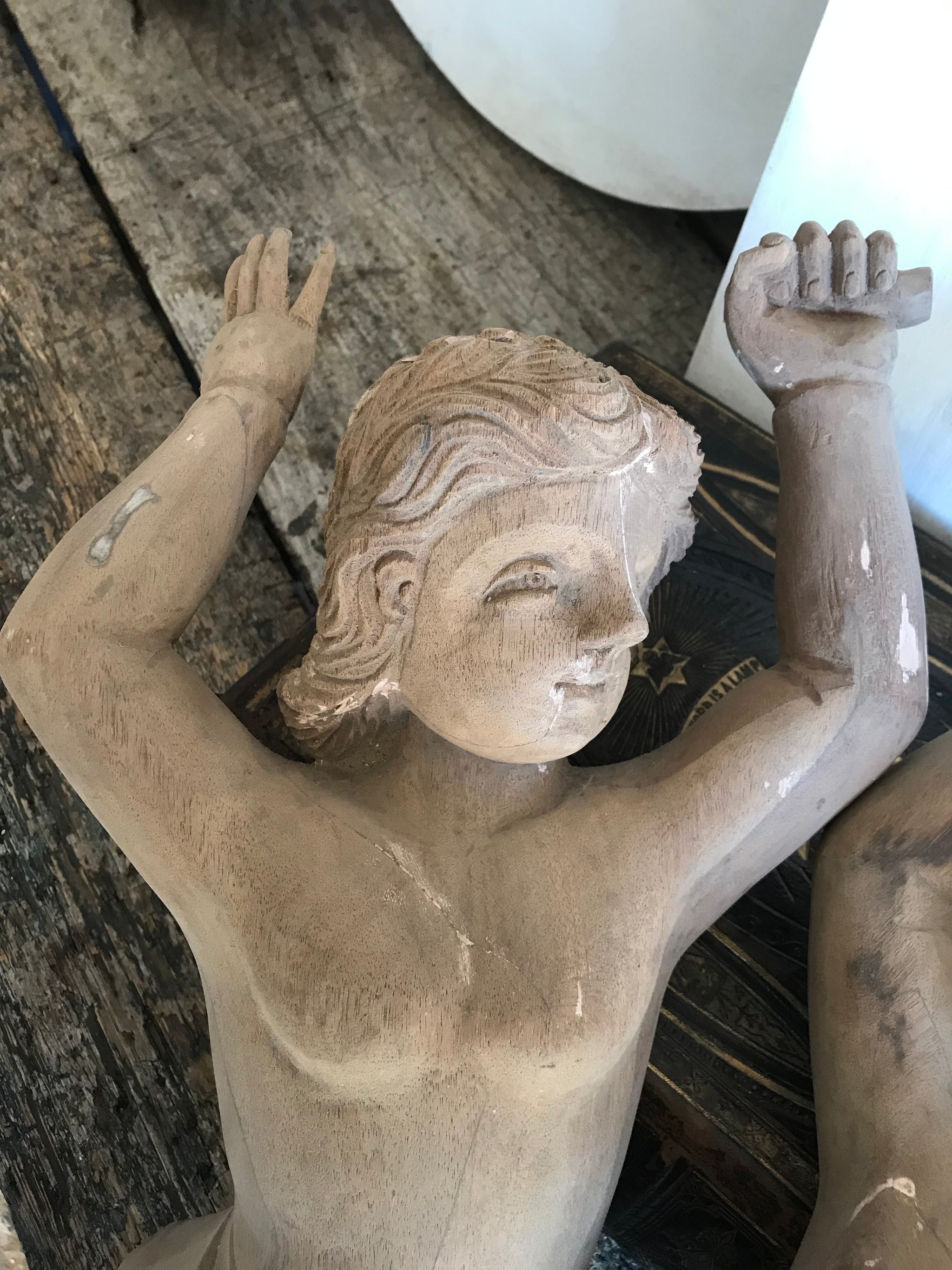 A pair of wooden hand-carved cherub figures