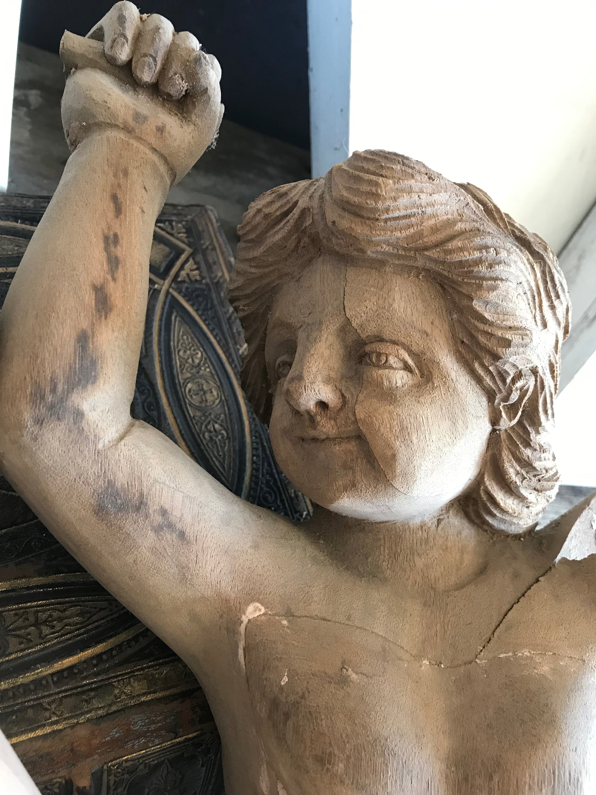 A pair of wooden hand-carved cherub figures