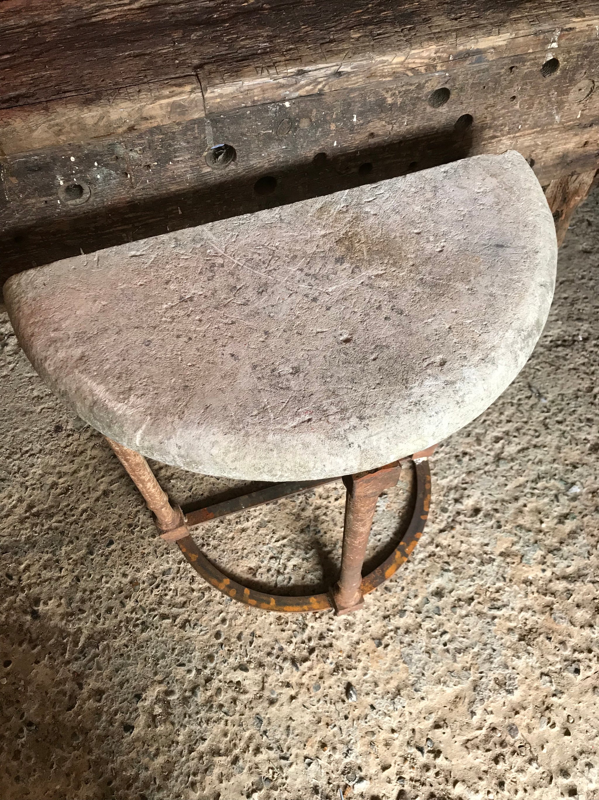 A pair of demilune cast iron and stone tables