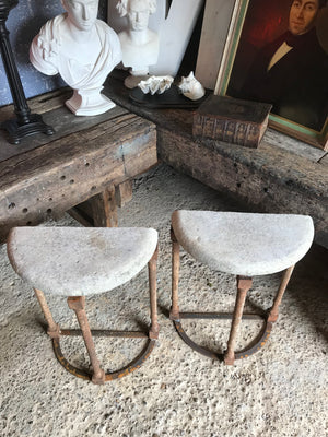 A pair of demilune cast iron and stone tables