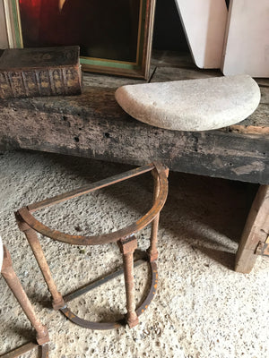 A pair of demilune cast iron and stone tables