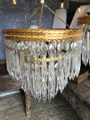 A gilt three tier crystal icicle droplet chandelier