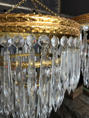 A gilt three tier crystal icicle droplet chandelier