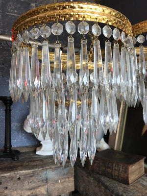 A gilt three tier crystal icicle droplet chandelier