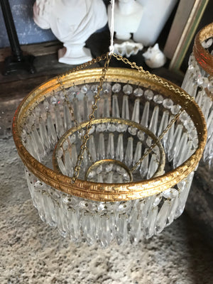 A gilt three tier crystal icicle droplet chandelier