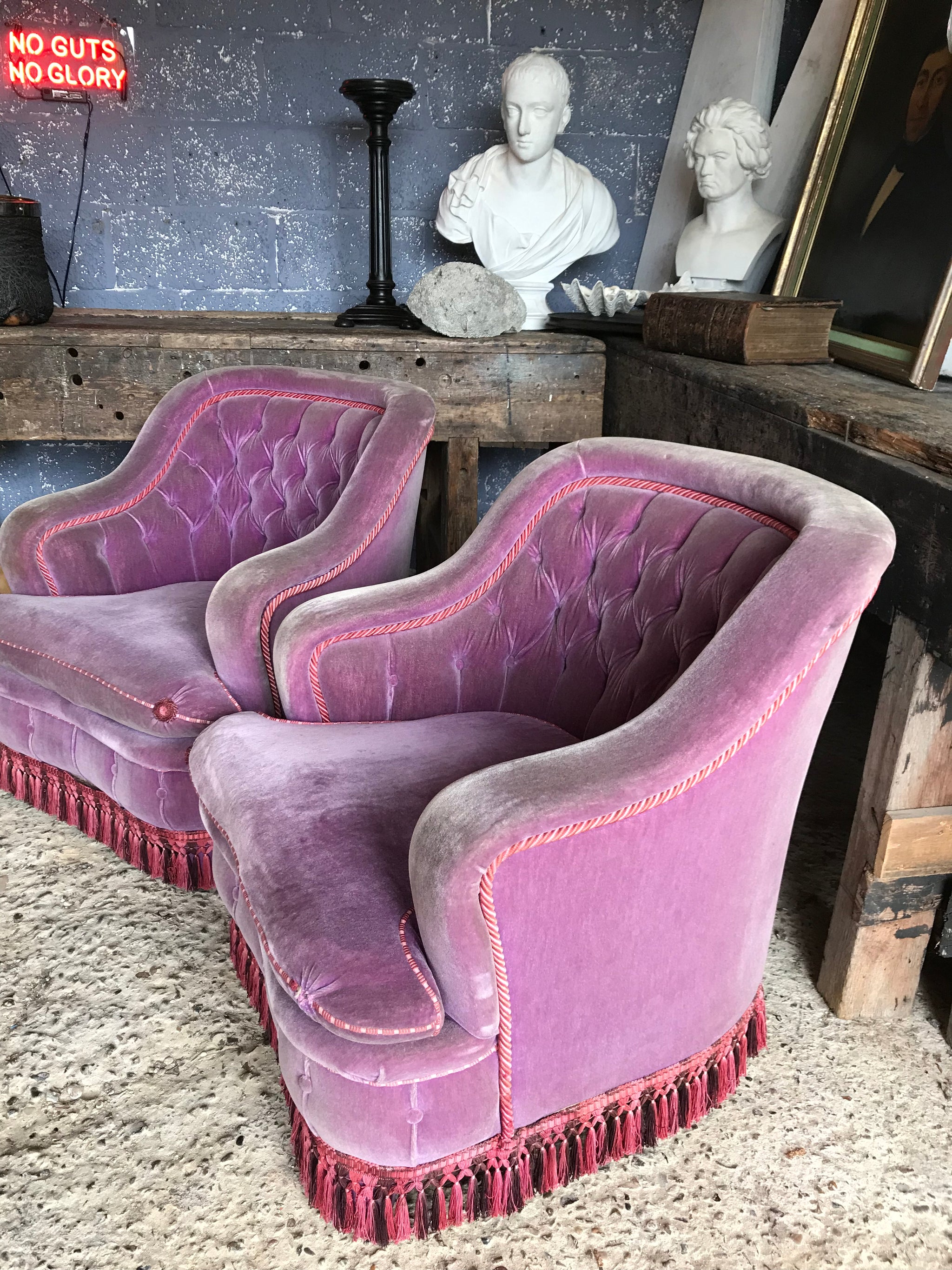 A glorious pair of purple velvet button back Hollywood Regency chairs