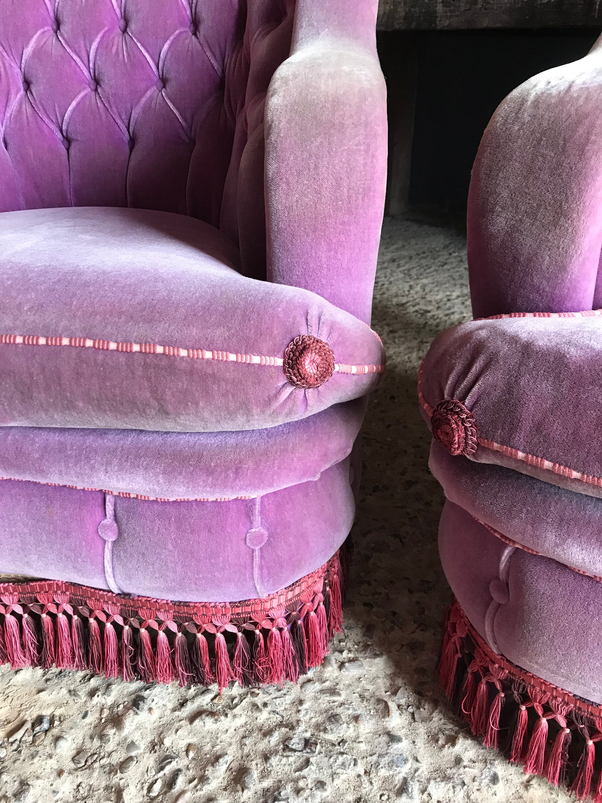 A glorious pair of purple velvet button back Hollywood Regency chairs
